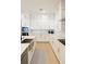 Spacious kitchen featuring white cabinets, quartz countertops, and a farmhouse sink at 13586 Abberwick Dr, Orlando, FL 32832