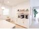 Modern kitchen with white cabinets, herringbone backsplash, and gold accents at 13586 Abberwick Dr, Orlando, FL 32832