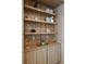 Built-in shelving unit with decorative items and storage at 13586 Abberwick Dr, Orlando, FL 32832