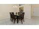 Elegant dining area with a glass-top table and six chairs at 13917 Timberland Dr # 201, Orlando, FL 32824