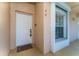 Condo entry with white door, tile floor, and a small window at 13917 Timberland Dr # 201, Orlando, FL 32824