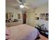 Bright bedroom with a ceiling fan, closet, and a vanity with a large mirror at 1420 Thousand Roses S Dr, Lake Wales, FL 33853