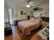 Cozy bedroom with wood floors, a mirrored headboard, and a ceiling fan at 1420 Thousand Roses S Dr, Lake Wales, FL 33853