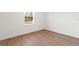 Bedroom with wood flooring, a window, and white walls at 15122 Sw 61St Court Rd, Ocala, FL 34473