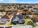 Aerial view of home with pool, showcasing backyard and surrounding neighborhood at 16143 Palmetto Hill St, Clermont, FL 34714