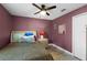 Bedroom with leopard print bedding and ceiling fan at 16143 Palmetto Hill St, Clermont, FL 34714