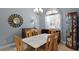 Dining area with a marble-top table and wooden chairs at 16143 Palmetto Hill St, Clermont, FL 34714