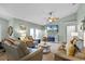 Bright living room with vaulted ceiling, fireplace, and large screen TV at 16143 Palmetto Hill St, Clermont, FL 34714