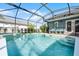 Inviting screened pool area with spa and ample seating at 16143 Palmetto Hill St, Clermont, FL 34714