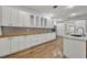 Modern kitchen with white cabinets and butcher block countertops at 1719 Finley Ave, Apopka, FL 32703