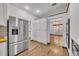 Modern kitchen with stainless steel appliances and white cabinets at 1719 Finley Ave, Apopka, FL 32703