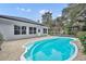 Inviting kidney-shaped pool with surrounding patio and pergola at 1719 Finley Ave, Apopka, FL 32703