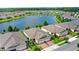 Stunning aerial view of a lakeside community showcases well-maintained homes, scenic water features, and lush greenery at 17597 Summersweet Way, Clermont, FL 34714