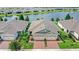 Charming single-story home boasts lush landscaping, brick driveway, and a picturesque waterfront view for serene living at 17597 Summersweet Way, Clermont, FL 34714