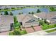 Charming single-story home boasts lush landscaping, brick driveway, and a picturesque waterfront view for serene living at 17597 Summersweet Way, Clermont, FL 34714