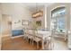 Formal dining room with large table, chandelier, and hardwood floors at 176 Nandina Ter, Winter Springs, FL 32708