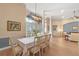 Formal dining room with large table, chandelier, and hardwood floors at 176 Nandina Ter, Winter Springs, FL 32708