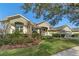 Green house exterior with red door, landscaping, and driveway at 176 Nandina Ter, Winter Springs, FL 32708