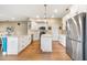 Modern kitchen with white cabinets, stainless steel appliances, and an island at 176 Nandina Ter, Winter Springs, FL 32708