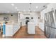 Modern kitchen with white cabinets, stainless steel appliances and large island at 176 Nandina Ter, Winter Springs, FL 32708