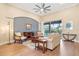 Light-filled living room features hardwood floors, comfortable seating, and a view to the backyard at 176 Nandina Ter, Winter Springs, FL 32708