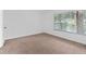 Simple carpeted bedroom with window and neutral walls at 1934 Abbington St # 37, Apopka, FL 32712