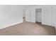 Carpeted bedroom with closet and access to another room at 1934 Abbington St # 37, Apopka, FL 32712