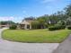 Tan house with covered carport and a large grassy area at 1934 Abbington St # 37, Apopka, FL 32712