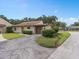 Tan house with red door, covered carport, and well-manicured landscaping at 1934 Abbington St # 37, Apopka, FL 32712