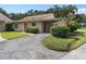 Tan house with red door, covered carport, and lush green lawn at 1934 Abbington St # 37, Apopka, FL 32712