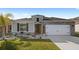 One-story home with gray siding, stone accents, and a two-car garage at 2022 Canton Park Dr, Winter Haven, FL 33881