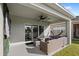 Covered patio with wicker furniture and ceiling fan, overlooking a pond at 2022 Canton Park Dr, Winter Haven, FL 33881