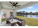 Relaxing covered patio overlooks a pond and features a sectional sofa at 2022 Canton Park Dr, Winter Haven, FL 33881