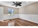 Bright bedroom with wood floors, ceiling fan, and window at 217 Pleasant Valley Dr, Daytona Beach, FL 32114