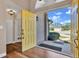 Open yellow door revealing view from entryway to backyard at 217 Pleasant Valley Dr, Daytona Beach, FL 32114