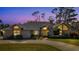 Brick house with gray roof, yellow door, and landscaped yard at 217 Pleasant Valley Dr, Daytona Beach, FL 32114