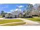 Brick house with gray roof, yellow door, and landscaped yard at 217 Pleasant Valley Dr, Daytona Beach, FL 32114