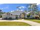 Brick house with gray roof, yellow door, and landscaped yard at 217 Pleasant Valley Dr, Daytona Beach, FL 32114