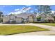 Brick house with gray roof, yellow door, and landscaped yard at 217 Pleasant Valley Dr, Daytona Beach, FL 32114