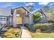 Brick home's entrance with yellow door and landscaped walkway at 217 Pleasant Valley Dr, Daytona Beach, FL 32114