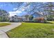 Brick house with circular driveway, landscaping, and large windows at 217 Pleasant Valley Dr, Daytona Beach, FL 32114