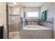 Bathroom with shower and garden tub at 220 Foxtail Loop, Davenport, FL 33837