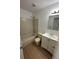 Bathroom with shower/tub combo, vanity, and light wood laminate flooring at 2210 Stonington Ave # 2210, Orlando, FL 32817