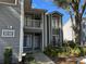 Gray condo building with entrance and landscaping at 2210 Stonington Ave # 2210, Orlando, FL 32817