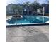 Community swimming pool with surrounding patio at 2210 Stonington Ave # 2210, Orlando, FL 32817