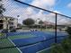 Community basketball court behind a chain link fence with surrounding residential buildings at 2407 Silver Palm Dr, Kissimmee, FL 34747