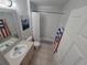 Bathroom with bathtub, vanity, and decorative wall art at 2407 Silver Palm Dr, Kissimmee, FL 34747