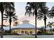 Community clubhouse at sunset with palm trees in the foreground at 2407 Silver Palm Dr, Kissimmee, FL 34747