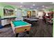 A game room with games, tables and chairs, and a bar at 2407 Silver Palm Dr, Kissimmee, FL 34747