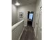 Hallway with wood-look floors and bedroom access at 2407 Silver Palm Dr, Kissimmee, FL 34747